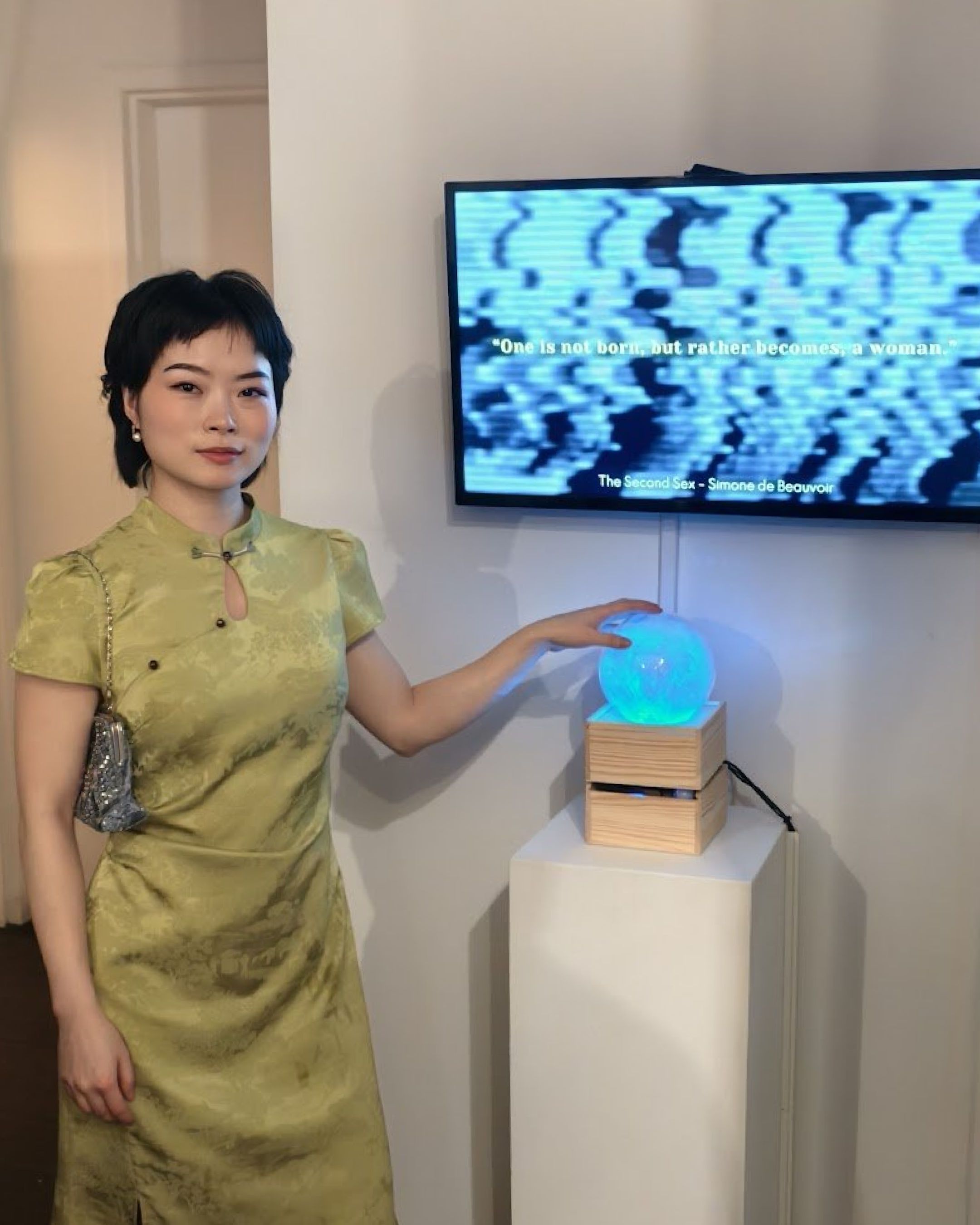 Visitor activating Vibe Altar by cradling the glowing crystal ball